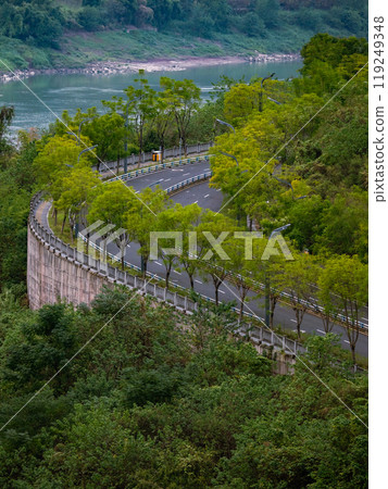 tall-rise buildings in a city hill, big river and winding uphill trail tall-rise buildings in a city hill, big river and winding uphill trail 119249348