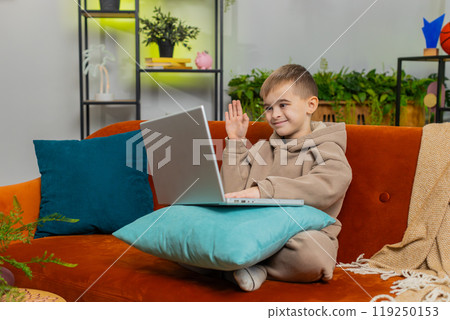 Preteen child boy looking at laptop camera, making video webcam conference call with friends family Preteen child boy looking at laptop camera, making video webcam conference call with friends family 119250153