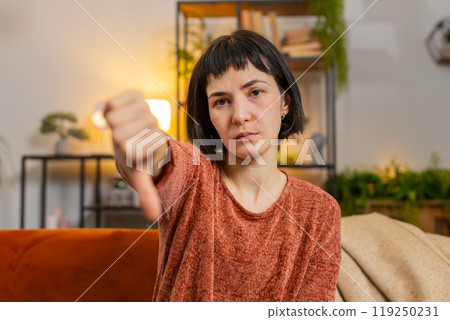 Woman showing thumbs down sign gesture, expressing discontent, disapproval dissatisfied dislike Woman showing thumbs down sign gesture, expressing discontent, disapproval dissatisfied dislike 119250231