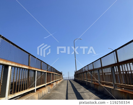 Pedestrian overpass and blue sky 119250334