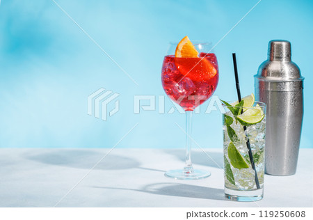 A variety of cocktails arranged on a table against a light blue background 119250608