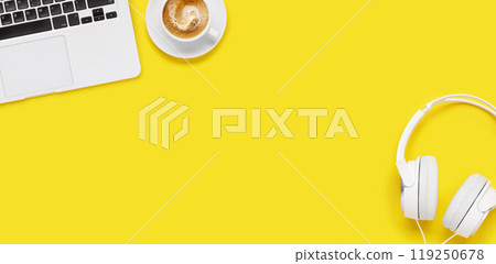 Laptop, headphones, and coffee cup arranged on a yellow background Laptop, headphones, and coffee cup arranged on a yellow background 119250678