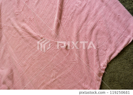 Threads coming out of the towel blanket and getting tangled 119250681