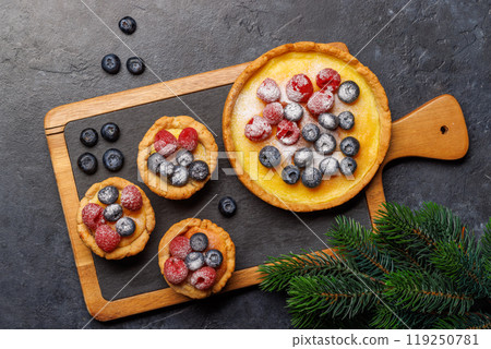 Festive delight: Christmas cupcakes adorned with berries Festive delight: Christmas cupcakes adorned with berries 119250781