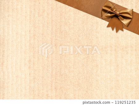 Paper package covered in adhesive tape with decorative bow. Masking tape with paper. Vintage grunge adhesive tape strips and bow on old cardboard texture of brown color. Copy space for text 119251235