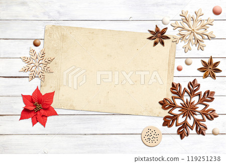 Eco friendly Christmas. Christmas background with retro wooden beads, poinsettia, star anise, snowflake on wooden boards. Copy space for text. Ecology, environmental conservation, zero waste concept Eco friendly Christmas. Christmas background with retro wooden beads, poinsettia, star anise, snowflake on wooden boards. Copy space for text. Ecology, environmental conservation, zero waste concept 119251238