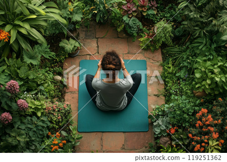 A serene moment of meditation in a vibrant garden sanctuary 119251362