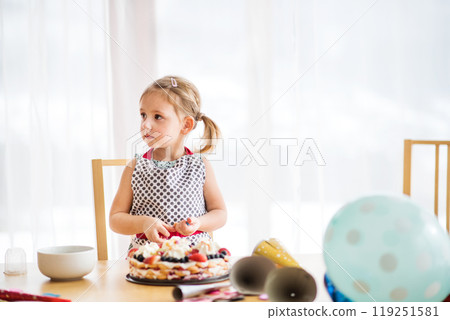 Daughter preparing and decorating cake for mom. Mothers day gift from girl. 119251581