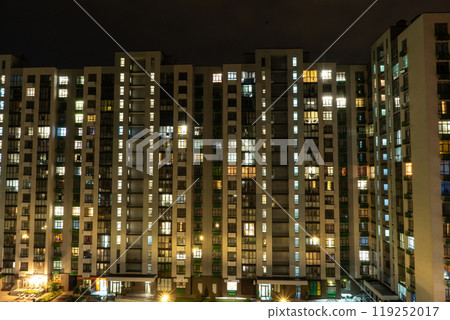 Night city. Multistorey residential building. The windows of the house glow in the dark. Night city. Multistorey residential building. The windows of the house glow in the dark. 119252017