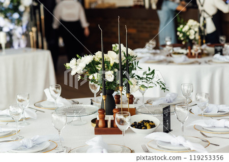 Luxurious restaurant. Luxurious interior, white tables, serving dishes and glasses for guests 119253356