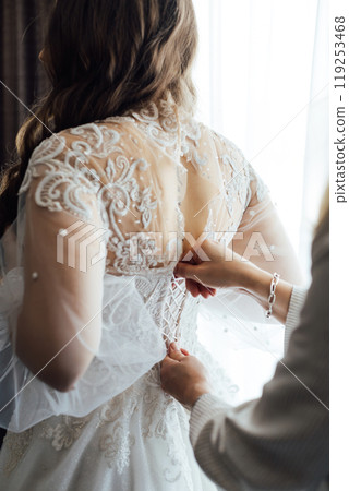 Bride and bridesmaids during the wedding preparations Bride and bridesmaids during the wedding preparations 119253468