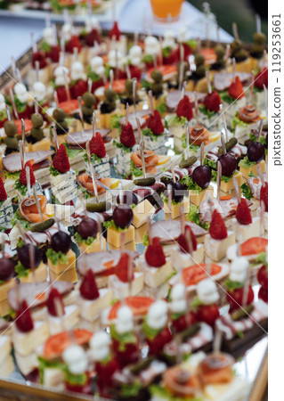 A large selection of various snacks for guests on a mirror surface. Buffet before an important event 119253661