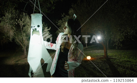 Zombie Woman Walks In The Dark Countryside On Halloween Night Among Ghosts 119253864