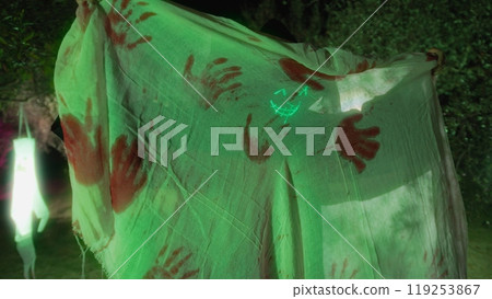 Halloween Monster Behind A Stained Curtain With Bloody Handles 119253867