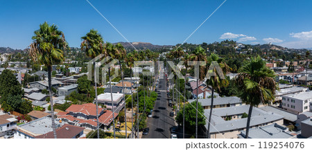 Aerial view of a residential area in Hollywood, Los Angeles, featuring palm lined streets, houses, low rise buildings, and the Hollywood Hills. Aerial view of a residential area in Hollywood, Los Angeles, featuring palm lined streets, houses, low rise buildings, and the Hollywood Hills. 119254076