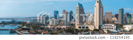 Panoramic aerial view of San Diego's skyline featuring the Manchester Grand Hyatt, USS Midway Museum, and Pacific Ocean in the background. 119254195