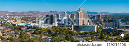 Reno, Nevada's skyline features high rise buildings and the Silver Legacy Resort Casino's silver dome, set against the Sierra Nevada mountains. 119254208