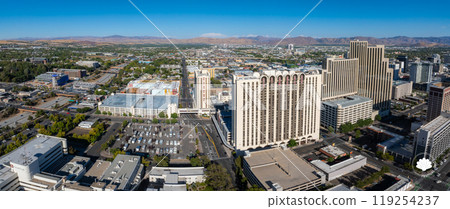 Aerial perspective of Reno, Nevada, featuring high rise buildings like Circus Circus, grid like streets, and the Sierra Nevada mountains in the background. 119254237