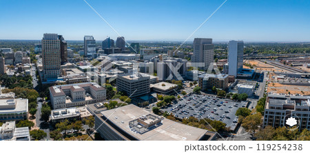 Aerial view of Sacramento's skyline featuring Wells Fargo Center, US Bank Tower, and Tower Bridge. The Sacramento River and tree lined streets are visible. Aerial view of Sacramento's skyline featuring Wells Fargo Center, US Bank Tower, and Tower Bridge. The Sacramento River and tree lined streets are visible. 119254238