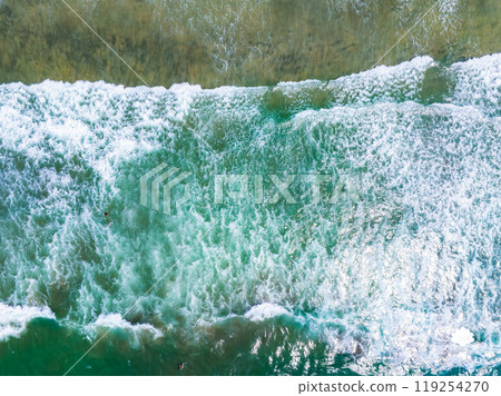 Aerial perspective of ocean waves meeting the shore in San Diego, California. Turquoise and emerald waters contrast with white foam, showcasing rhythmic patterns. Aerial perspective of ocean waves meeting the shore in San Diego, California. Turquoise and emerald waters contrast with white foam, showcasing rhythmic patterns. 119254270