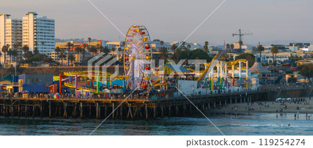 The image features Santa Monica Pier's amusement park with a Ferris wheel and roller coaster, set against a backdrop of beach, palm trees, and cityscape. 119254274