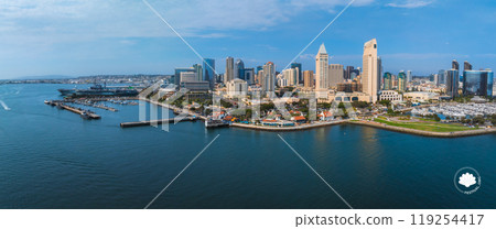 Downtown San Diego's skyline features modern skyscrapers and historic buildings, with One America Plaza and the USS Midway Museum by the marina. 119254417
