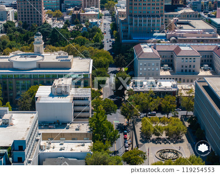 Aerial view of downtown Sacramento, California, highlighting the City Hall dome, tree lined streets, and a mix of historic and modern architecture. 119254553