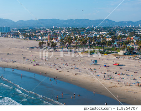 Aerial view of Venice Beach in Los Angeles, California, featuring sandy shores, palm trees, and the cityscape with Santa Monica Mountains in the background. Aerial view of Venice Beach in Los Angeles, California, featuring sandy shores, palm trees, and the cityscape with Santa Monica Mountains in the background. 119254707