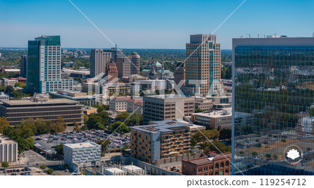 Aerial view of Sacramento, California, highlighting modern skyscrapers like Wells Fargo Center and the iconic California State Capitol dome. Aerial view of Sacramento, California, highlighting modern skyscrapers like Wells Fargo Center and the iconic California State Capitol dome. 119254712