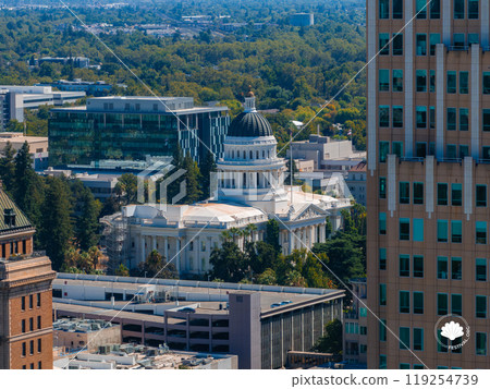 Aerial perspective of Sacramento, California, highlighting the California State Capitol with its white dome, surrounded by modern buildings and greenery. Aerial perspective of Sacramento, California, highlighting the California State Capitol with its white dome, surrounded by modern buildings and greenery. 119254739