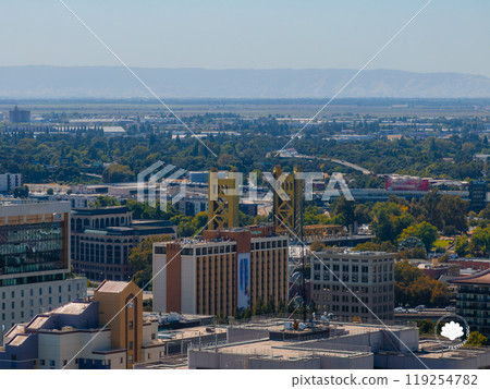 Aerial view of Sacramento highlighting the yellow gold Tower Bridge, surrounded by modern and historic buildings, greenery, and distant mountains. Aerial view of Sacramento highlighting the yellow gold Tower Bridge, surrounded by modern and historic buildings, greenery, and distant mountains. 119254782