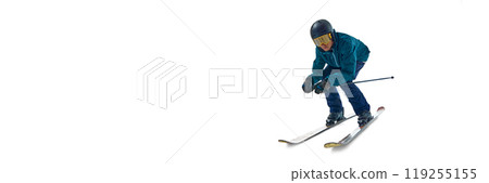 Banner. Skier crouches low, picking up speed as he glides against white studio background with negative space to insert text. 119255155