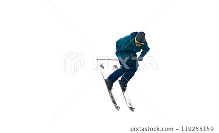 Active male skier in mid-motion, leans forward for swift descent. Movement and intensity of his expression show determination. 119255159