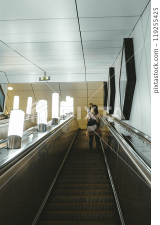 Escalator steps close-up. Deep tunnel. Public transport. Moscow metro. Passengers go up the escalator 119255425