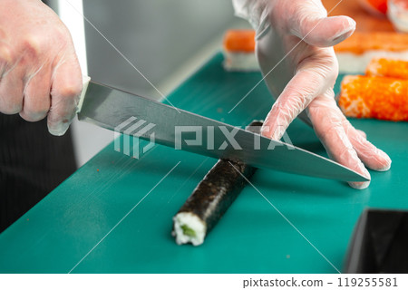 Preparing sushi rolls with fresh ingredients at a culinary studio 119255581