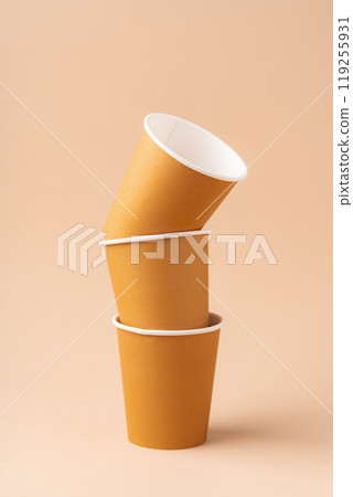 Paper cups stacked on a neutral background for a visually appealing display 119255931