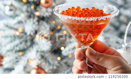 Glass of Red Caviar Held Against Festive Background 119256200