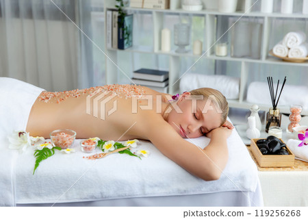 Woman customer having exfoliation treatment in luxury spa. Quiescent 119256268