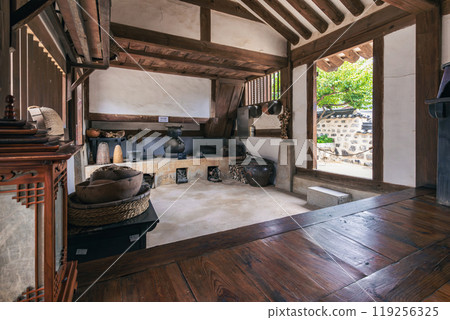 Traditional Korean kitchen at Namsangol Hanok Village featuring rustic wooden beams, stone floors, and traditional cooking tools. Traditional Korean kitchen at Namsangol Hanok Village featuring rustic wooden beams, stone floors, and traditional cooking tools. 119256325