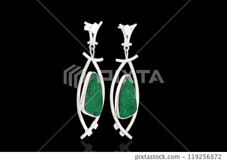 Beautiful gold, silver earrings with Uvarovite stone on a black background Beautiful gold, silver earrings with Uvarovite stone on a black background 119256872