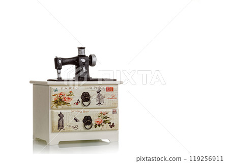 jewelry box with decorative sewing machine on a white background jewelry box with decorative sewing machine on a white background 119256911