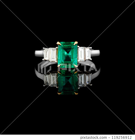 beautiful ring made of gold with precious stones emerald and diamonds on a black background 119256912