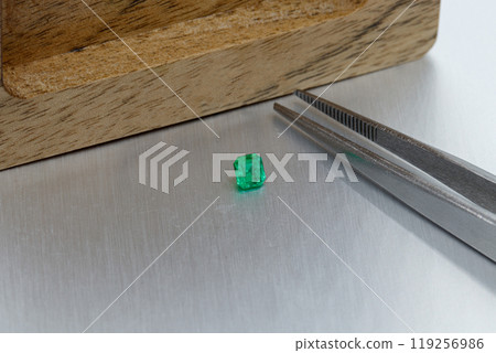 macro mineral faceted stone Emeralds on a gray background macro mineral faceted stone Emeralds on a gray background 119256986