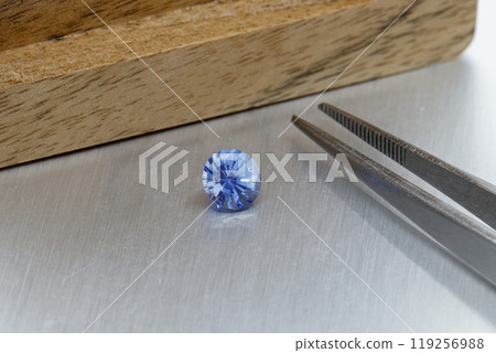 macro mineral faceted stone Sapphire on a gray background macro mineral faceted stone Sapphire on a gray background 119256988