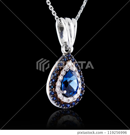 beautiful pendant with sapphire with a gold chain on a black background 119256996