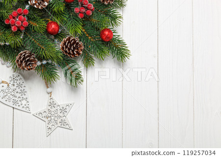 Christmas composition, Christmas tree branch with toys, cones on a wooden background 119257034