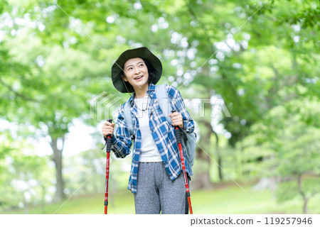 Middle-aged woman climbing a mountain 119257946