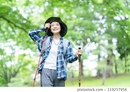Middle-aged woman climbing a mountain Middle-aged woman climbing a mountain 119257956