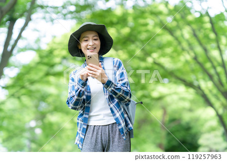 Middle-aged woman climbing a mountain 119257963