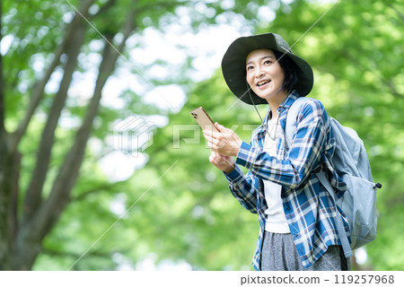 Middle-aged woman climbing a mountain Middle-aged woman climbing a mountain 119257968